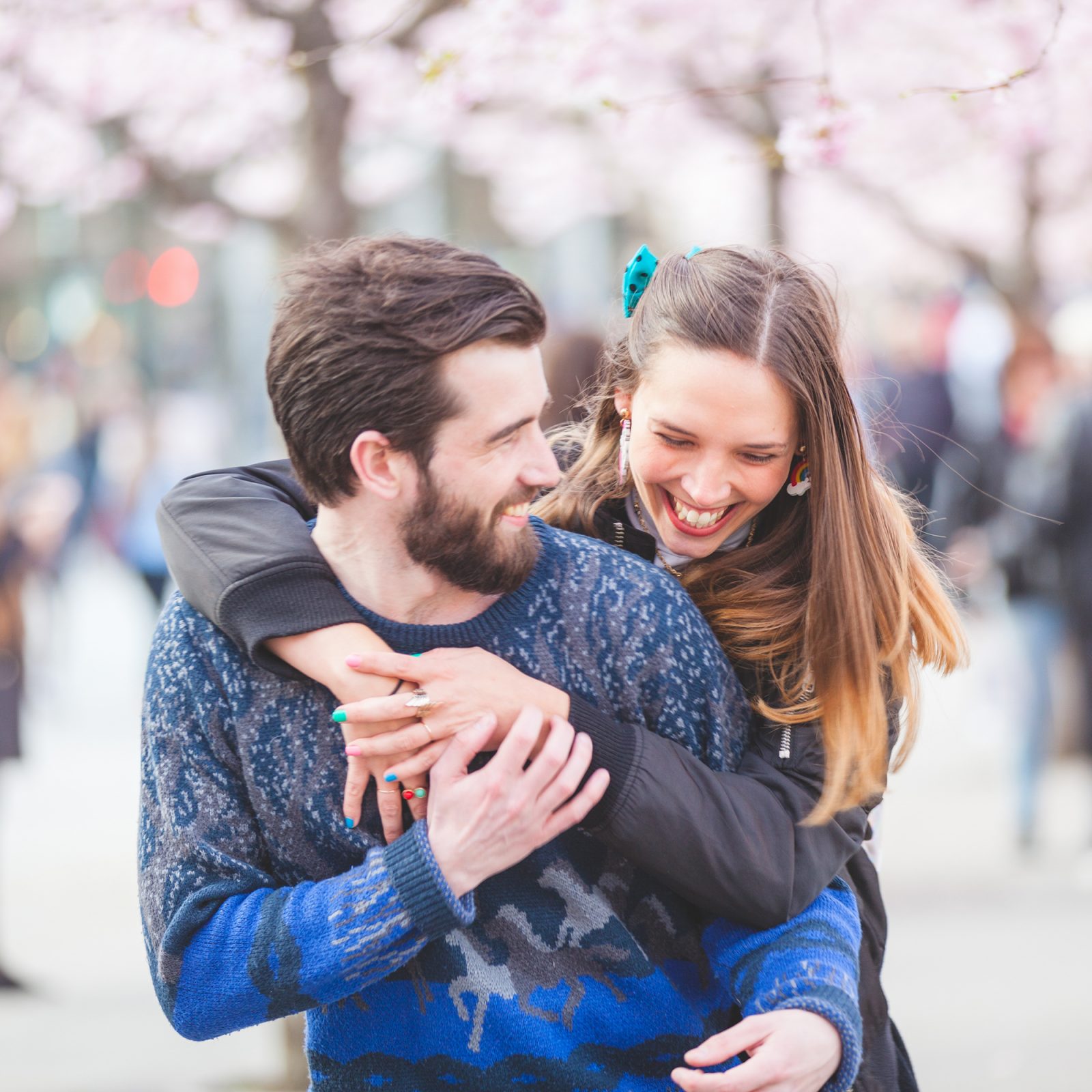 Happy hipster couple in Stockholm with cherry blossoms